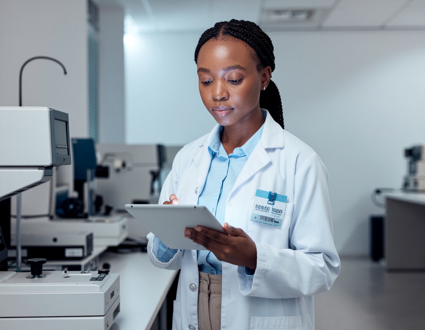 Optical lab technician managing work from a tablet